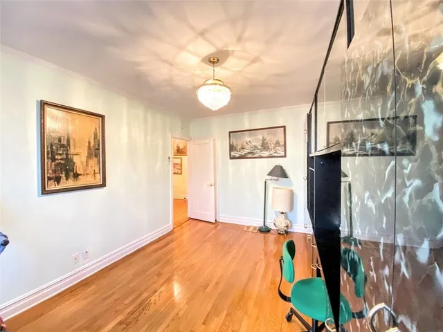 a kitchen with a table chairs refrigerator and microwave