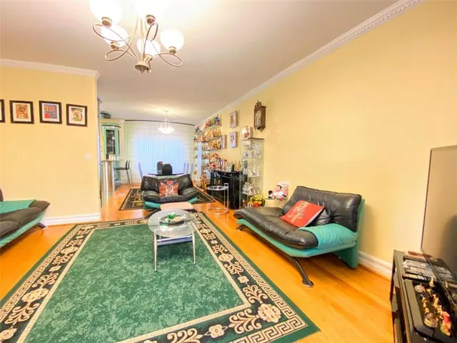 a living room with patio furniture and a flat screen tv