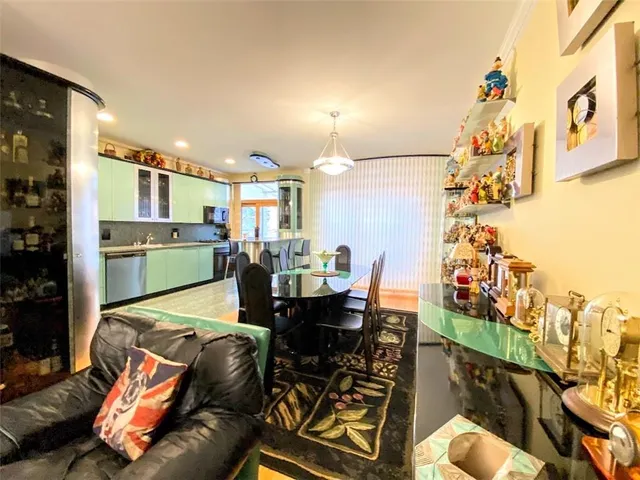 a dining room filled with furniture and a kitchen view