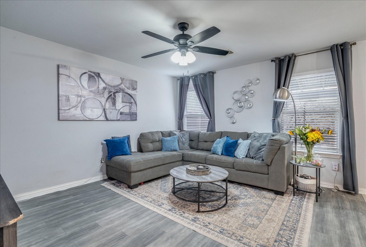 148 Buttercup Way Kyle, TX 78640 - Photo 5 of 33 Living room featuring ceiling fan and wood finished floors