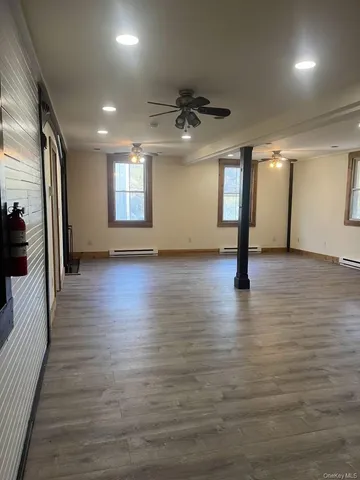 a view of a living room with furniture and a flat screen tv