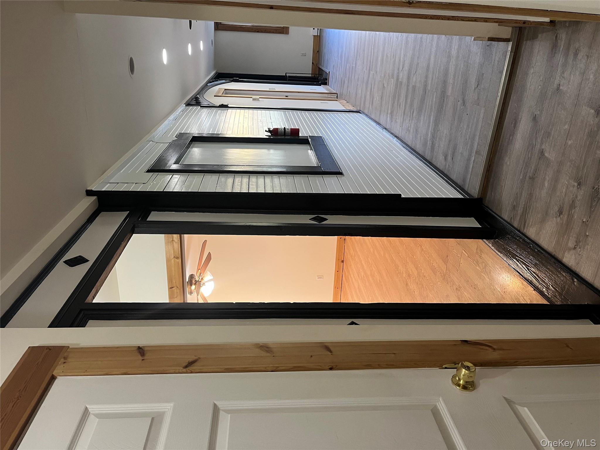 1027 Beekman Road, Unit 1A Hopewell Junction, NY 12533 - Photo 2 of 7 a view of a hallway with wooden floor and staircase