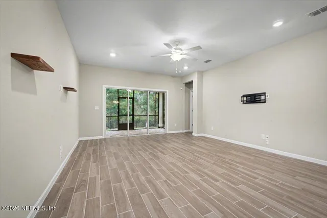 wooden floor in an empty room with a window