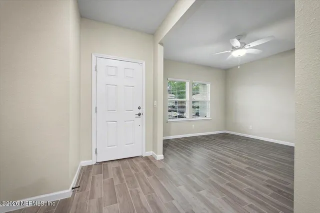 wooden floor in an empty room with a window