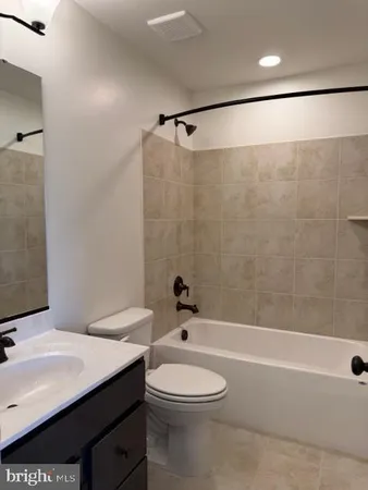 a bathroom with a sink a toilet and a bathtub