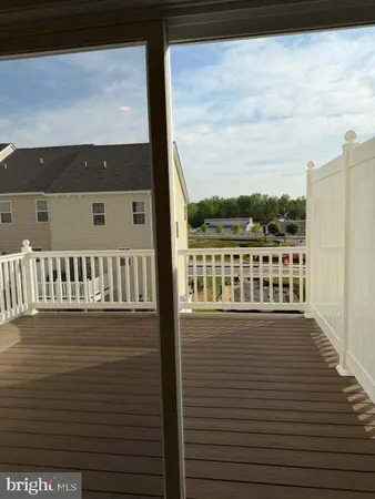 a view of a balcony with wooden floor and city view