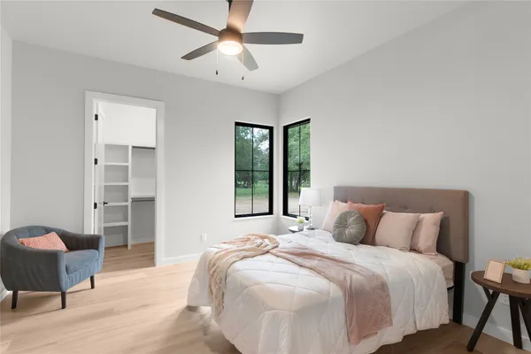 a bedroom with a bed and a chandelier