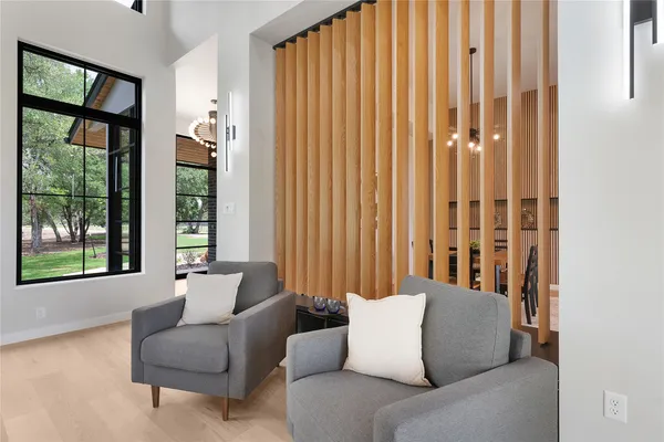a living room with furniture and large windows