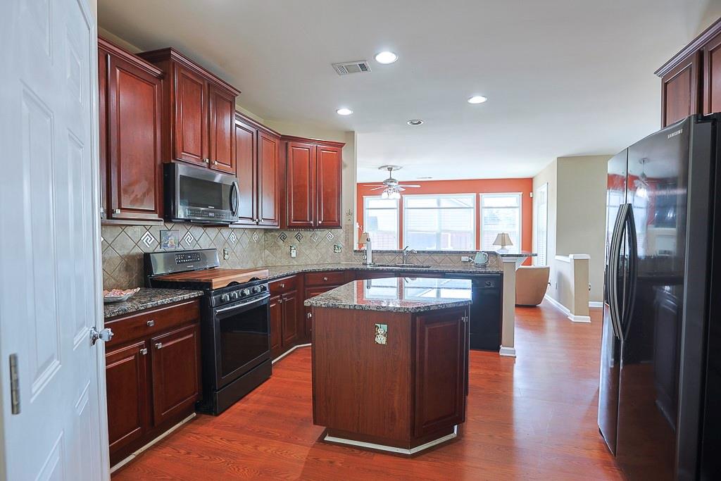 300 Hampton Place Canton, GA 30115 - Photo 13 of 82 a kitchen with stainless steel appliances granite countertop a refrigerator a stove top oven a sink and dishwasher