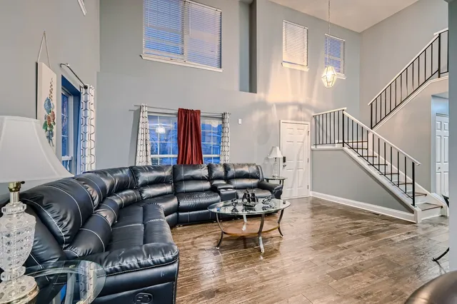 a living room with furniture and a dining table