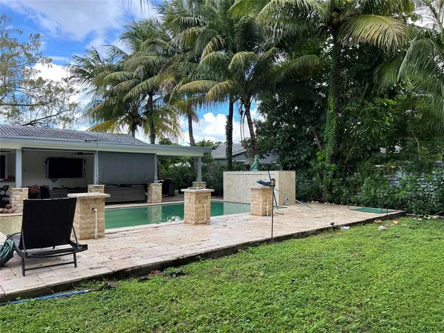 a view of backyard with seating area and green space