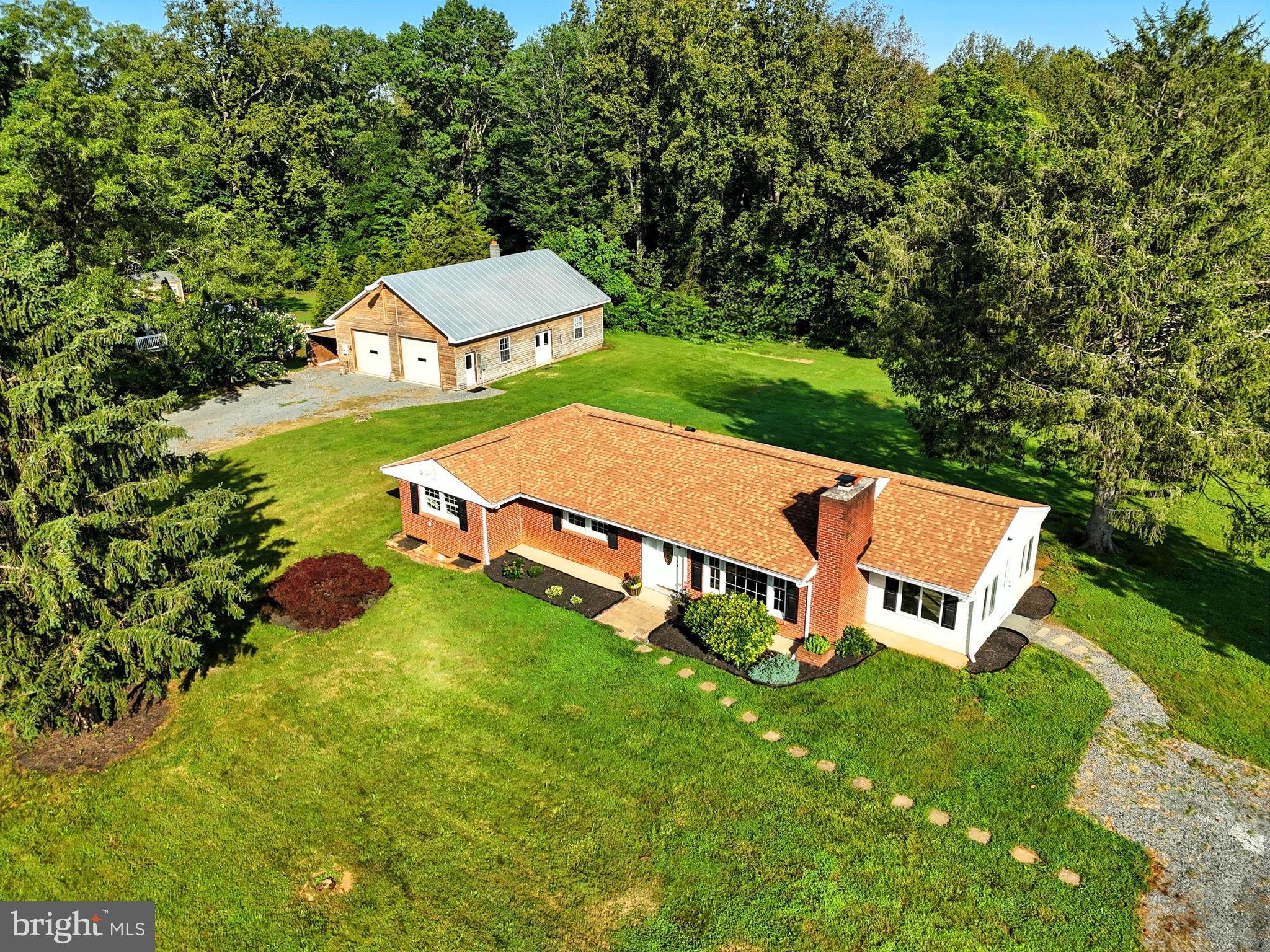 an aerial view of a house with yard swimming pool and outdoor seating