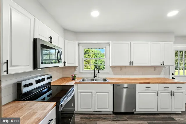 a kitchen that has a sink and a stove in it