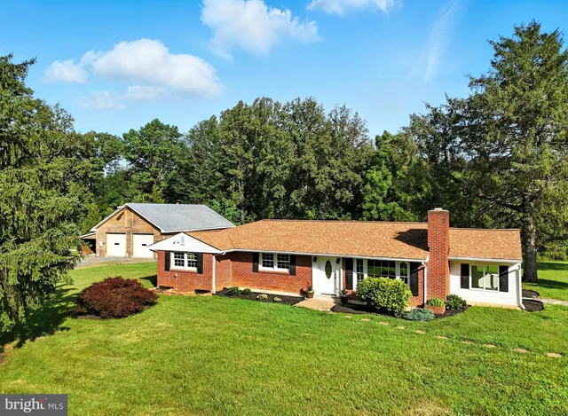 a aerial view of a house with yard and green space