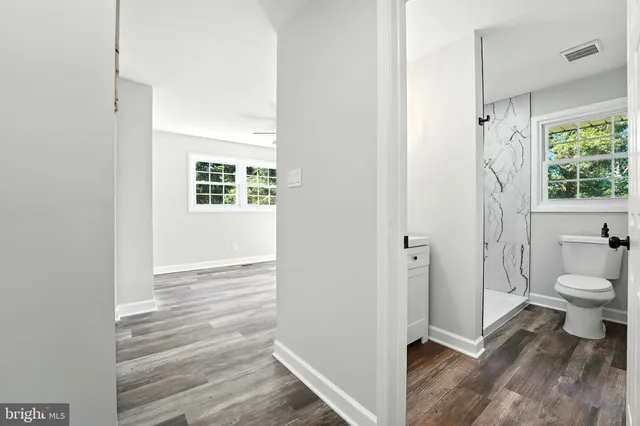 a bathroom with a toilet and a shower
