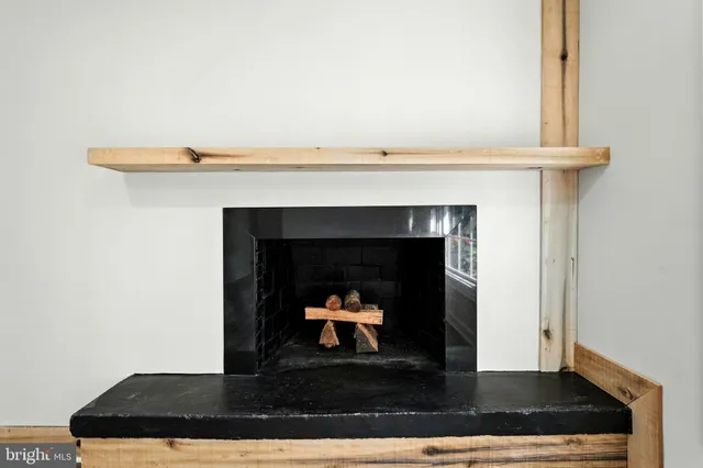 a living room with a fireplace and a wooden floor