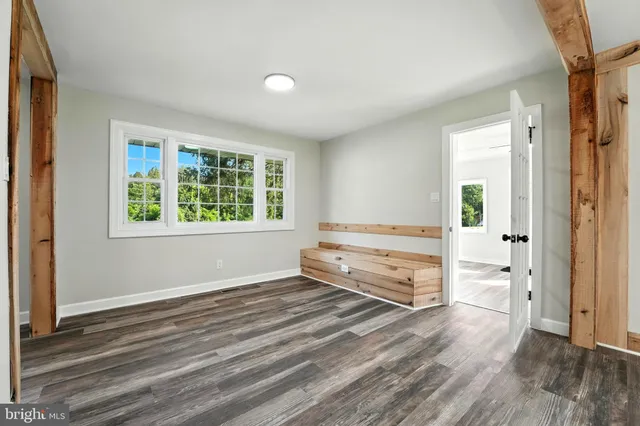 an empty room with windows and closet