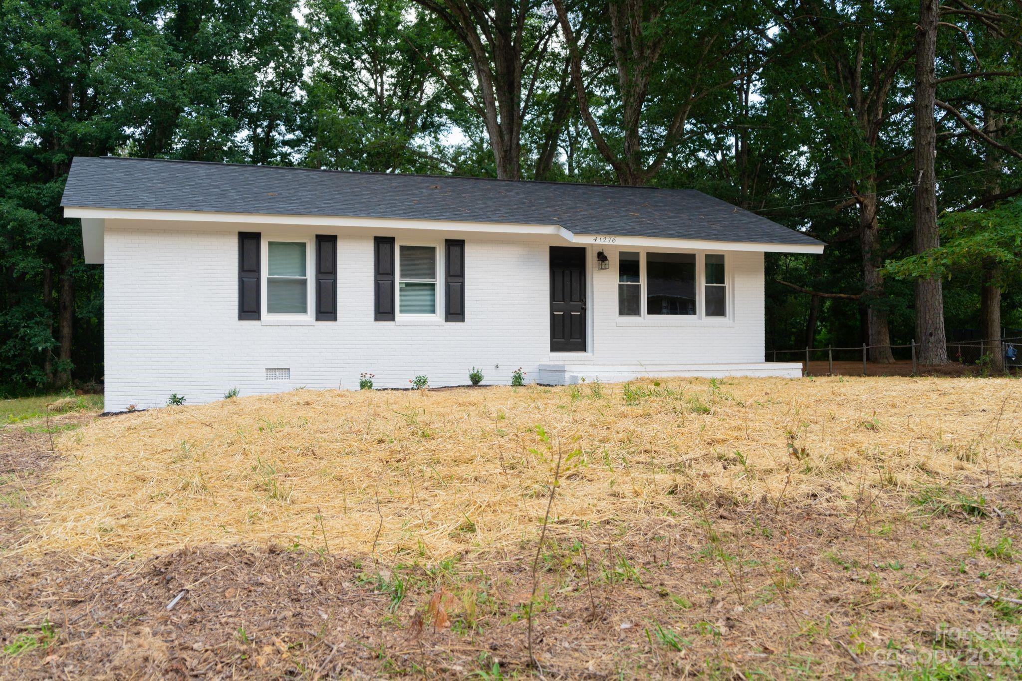 41276 Kings Road New London, NC 28127 - Photo 1 of 12 a front view of house with yard and trees around
