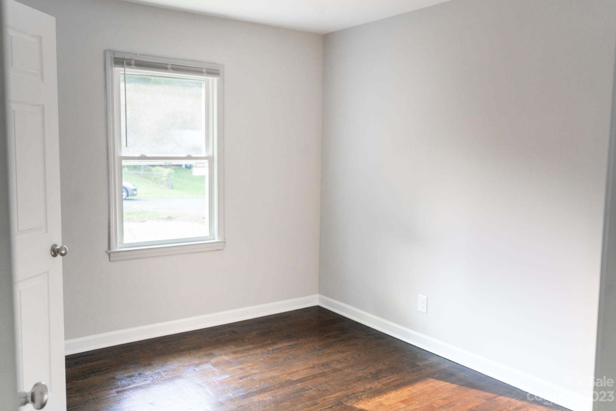 41276 Kings Road New London, NC 28127 - Photo 11 of 12 an empty room with wooden floor and a window