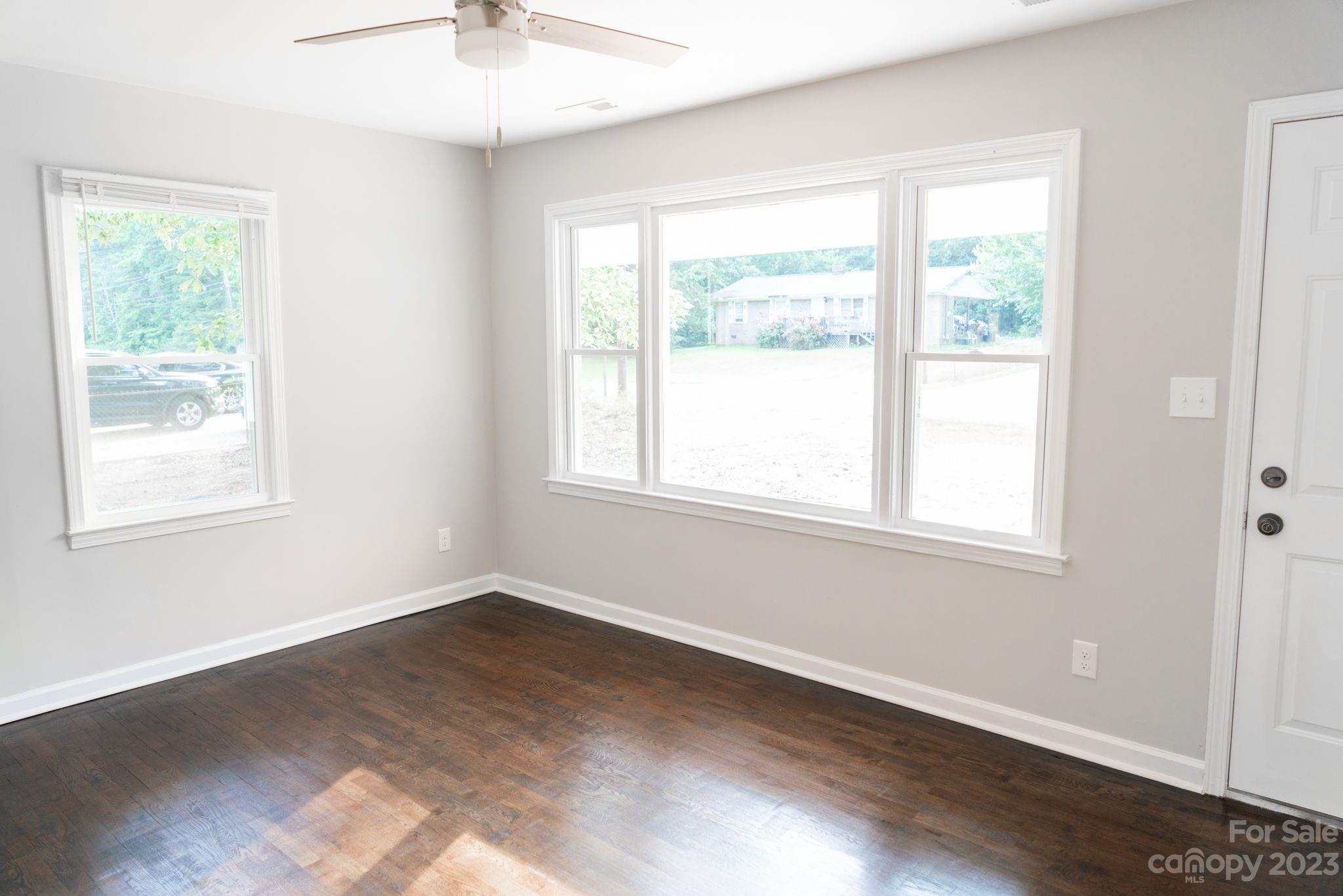 41276 Kings Road New London, NC 28127 - Photo 3 of 12 a view of an empty room with wooden floor and a window