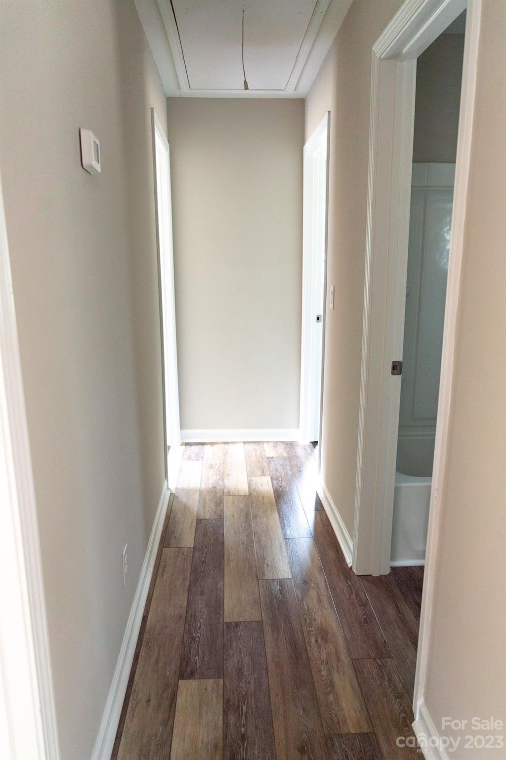 41276 Kings Road New London, NC 28127 - Photo 6 of 12 an empty room with wooden floor and entrance