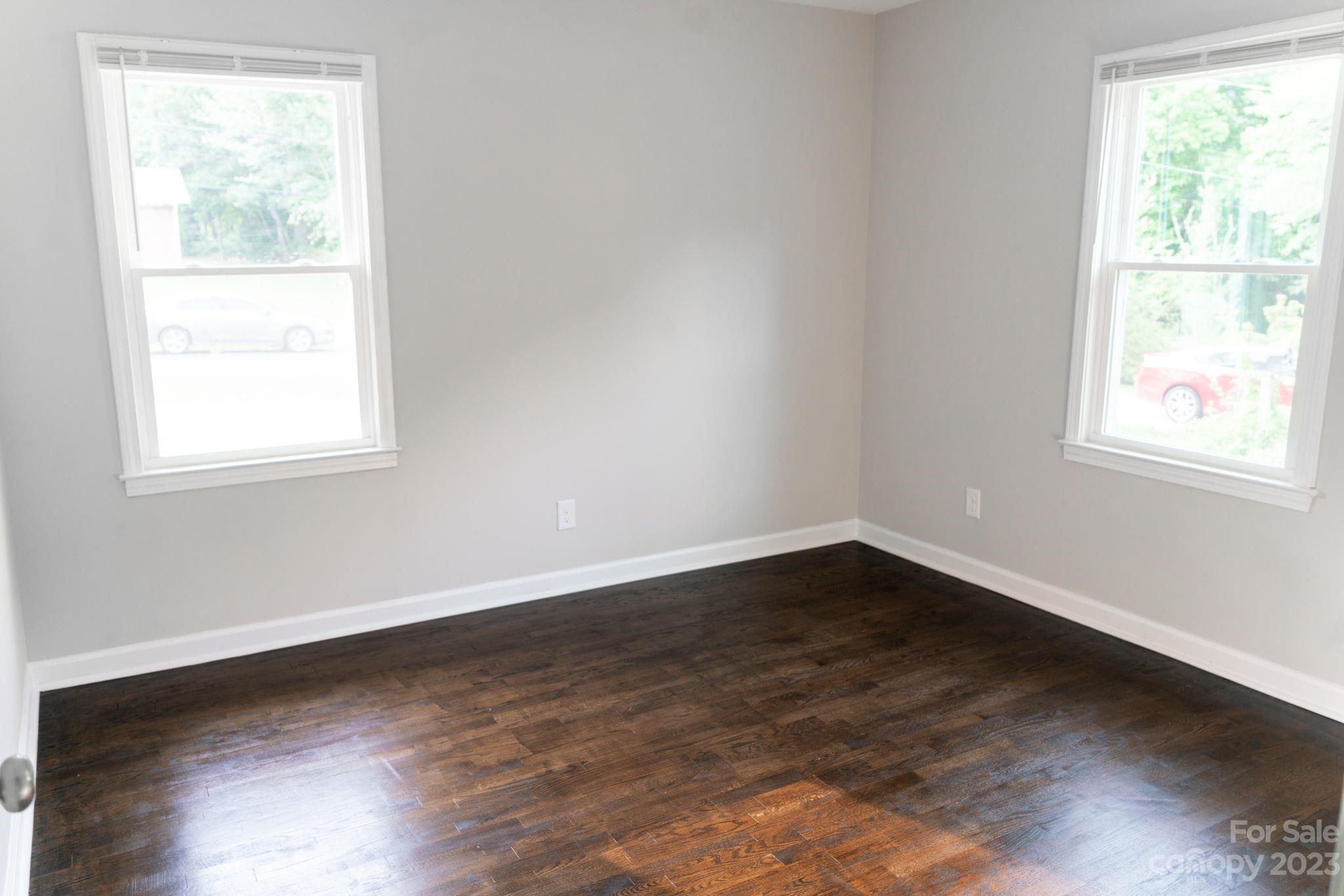 41276 Kings Road New London, NC 28127 - Photo 10 of 12 an empty room with wooden floor and windows