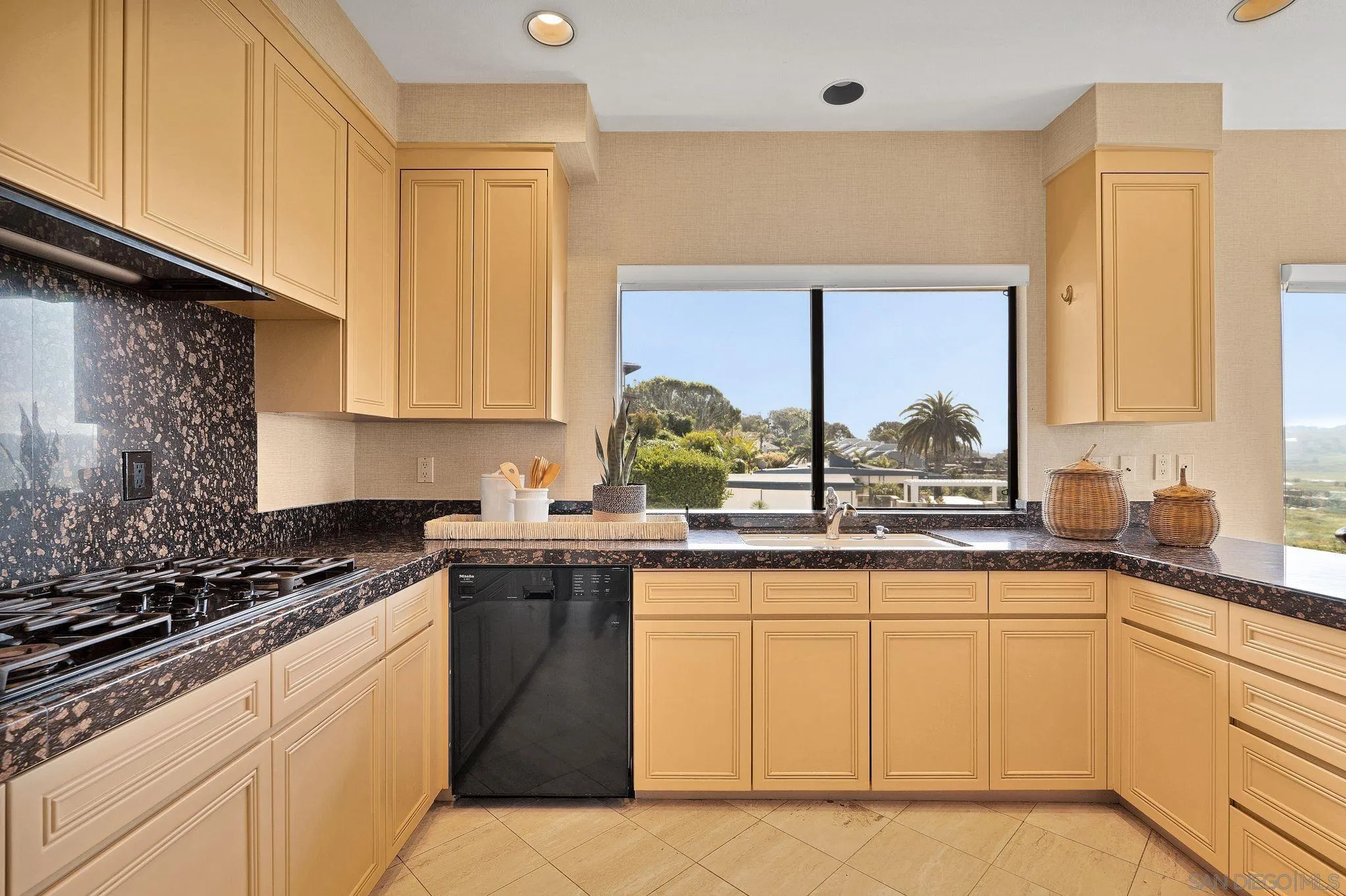 560 Torrey Point Road Del Mar, CA 92014 - Photo 11 of 35 a kitchen with a sink stove and cabinets