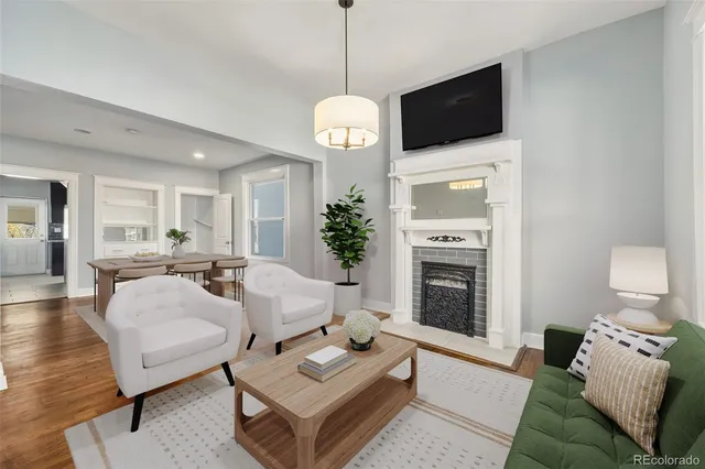 a living room with furniture a fireplace and a flat screen tv