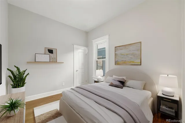a bedroom with a bed and a potted plant