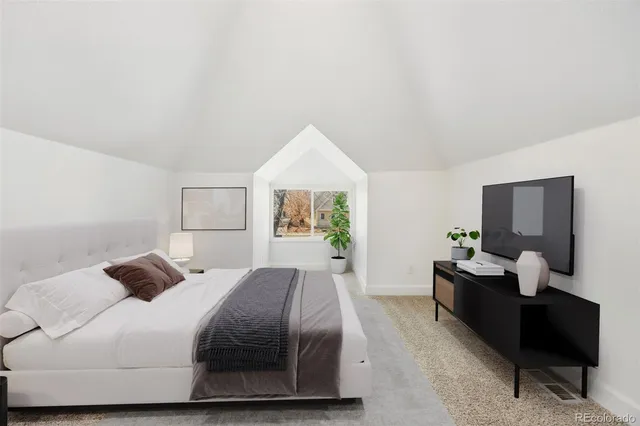 a bedroom with a bed and window