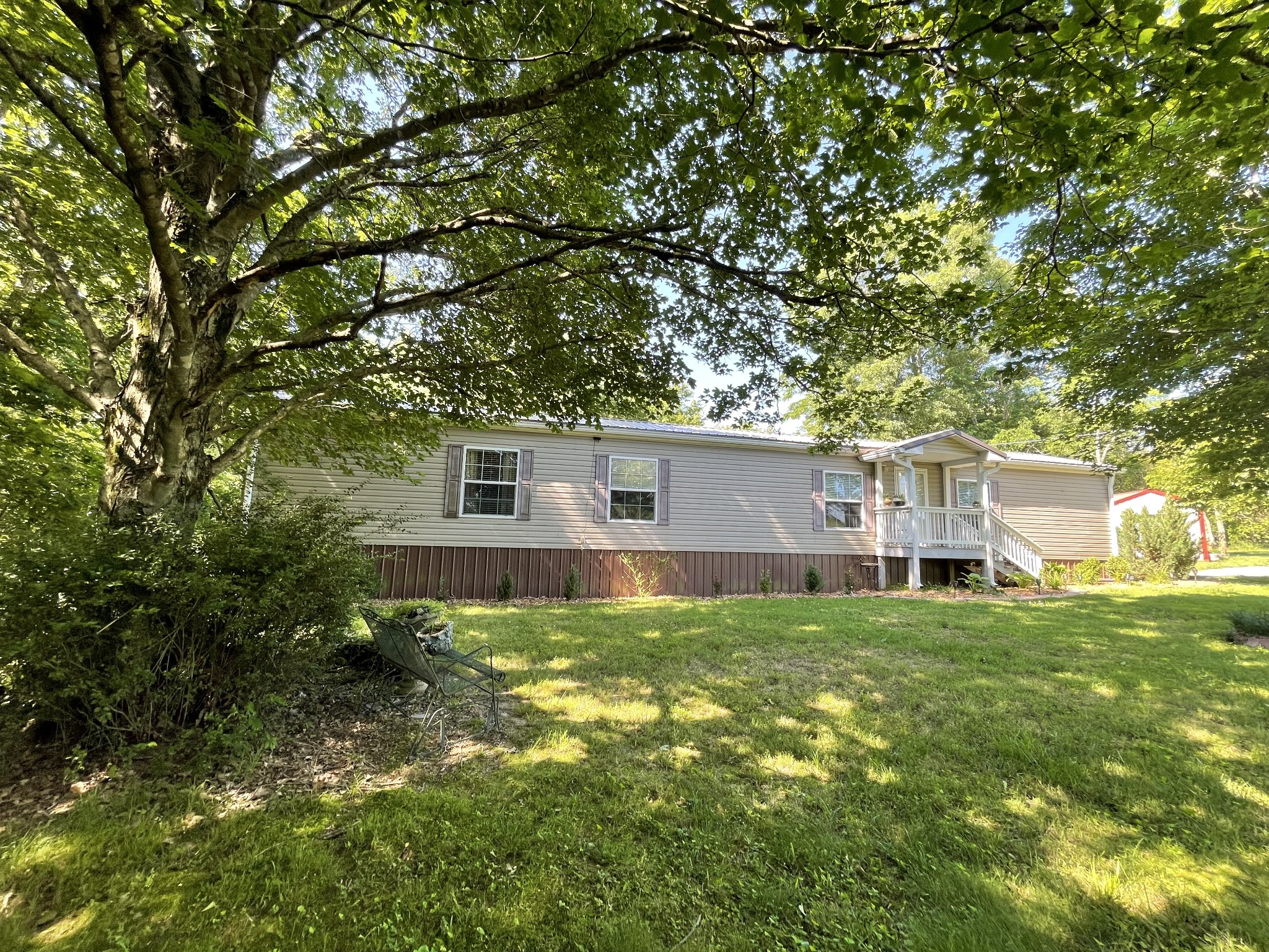 4470 St Paul Road Woodlawn, TN 37191 - Photo 4 of 9 a backyard of a house with table and chairs