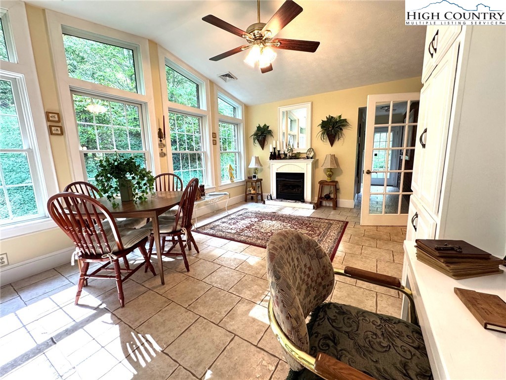 11644 Highway 88 Creston, NC 28615 - Photo 21 of 50 a living room with furniture a fireplace and a floor to ceiling window