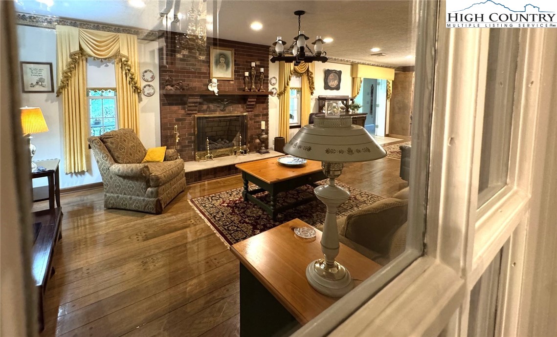 11644 Highway 88 Creston, NC 28615 - Photo 23 of 50 a living room with furniture and a fireplace