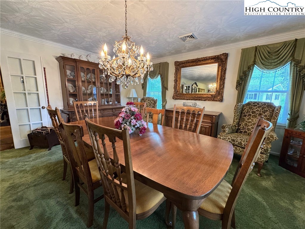 11644 Highway 88 Creston, NC 28615 - Photo 30 of 50 a view of a dining room with furniture and a chandelier