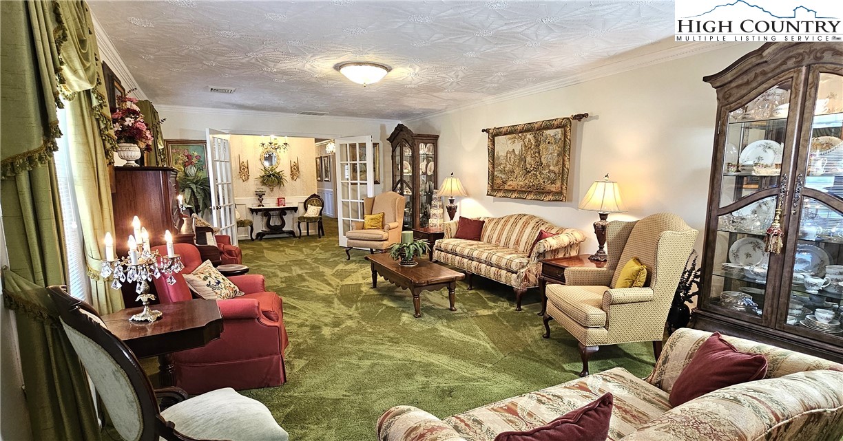 11644 Highway 88 Creston, NC 28615 - Photo 32 of 50 a living room with furniture fireplace and a large window