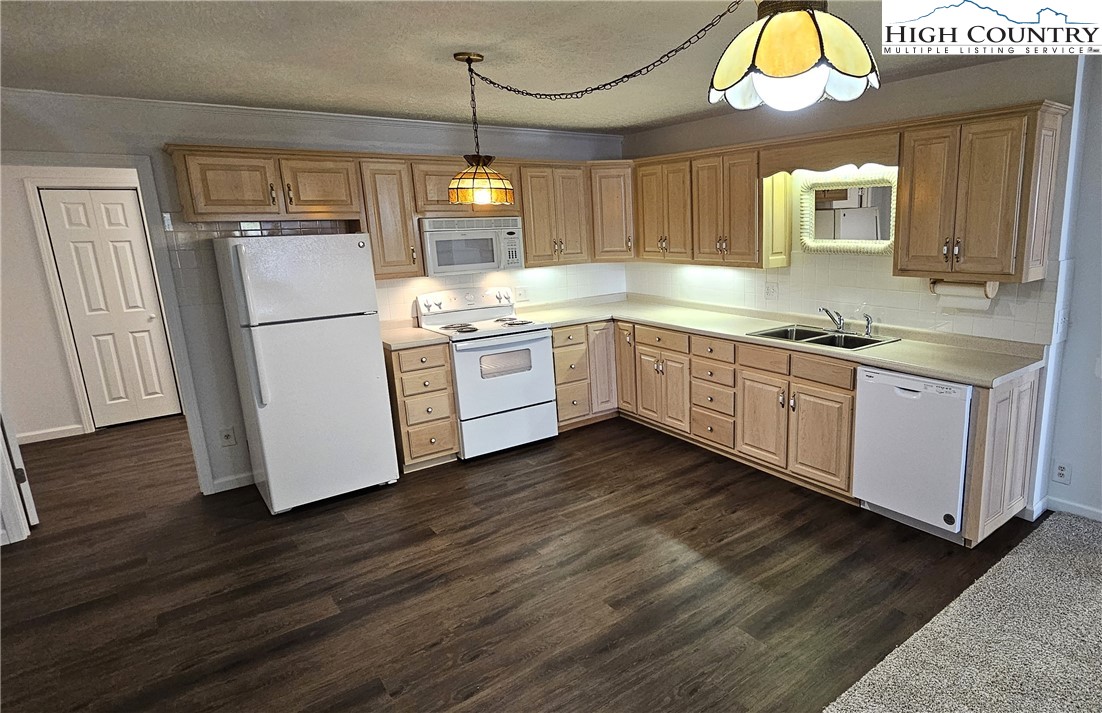 11644 Highway 88 Creston, NC 28615 - Photo 43 of 50 a kitchen with cabinets a sink and appliances