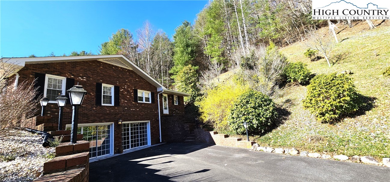 11644 Highway 88 Creston, NC 28615 - Photo 7 of 50 a front view of a house with a yard