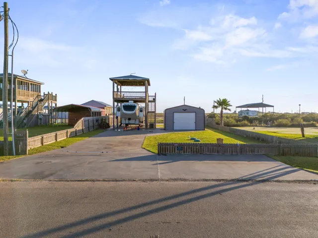 a view of a swimming pool with lawn chairs under an umbrella