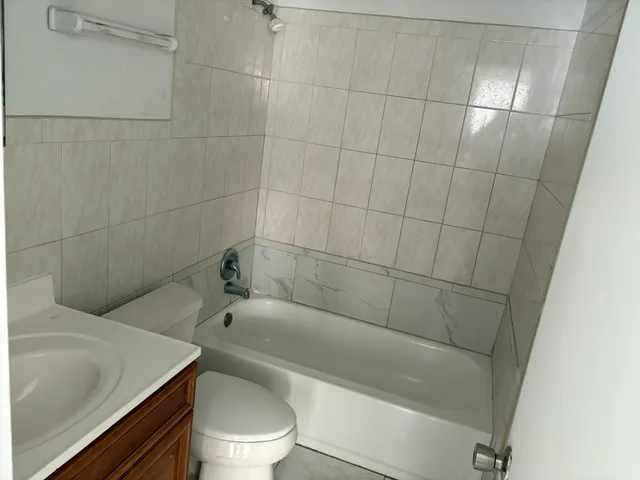 a bathroom with a bathtub and toilet