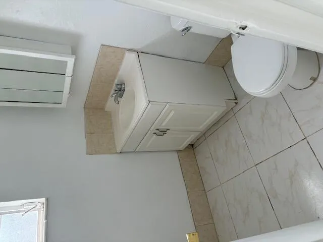 a bathroom with a window and a mirror