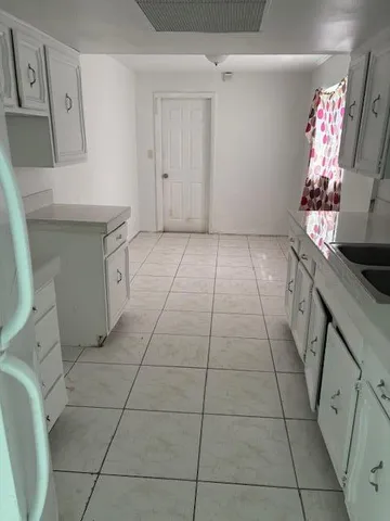a kitchen with granite countertop cabinets and stove