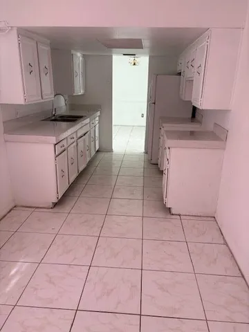 a kitchen with stainless steel appliances a sink stove and cabinets