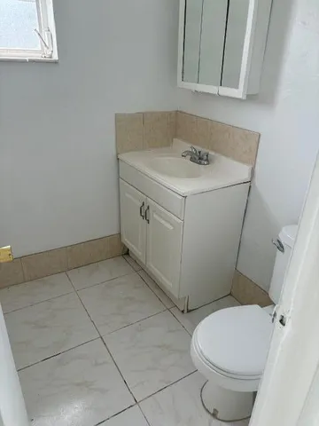 a bathroom with a sink toilet and vanity