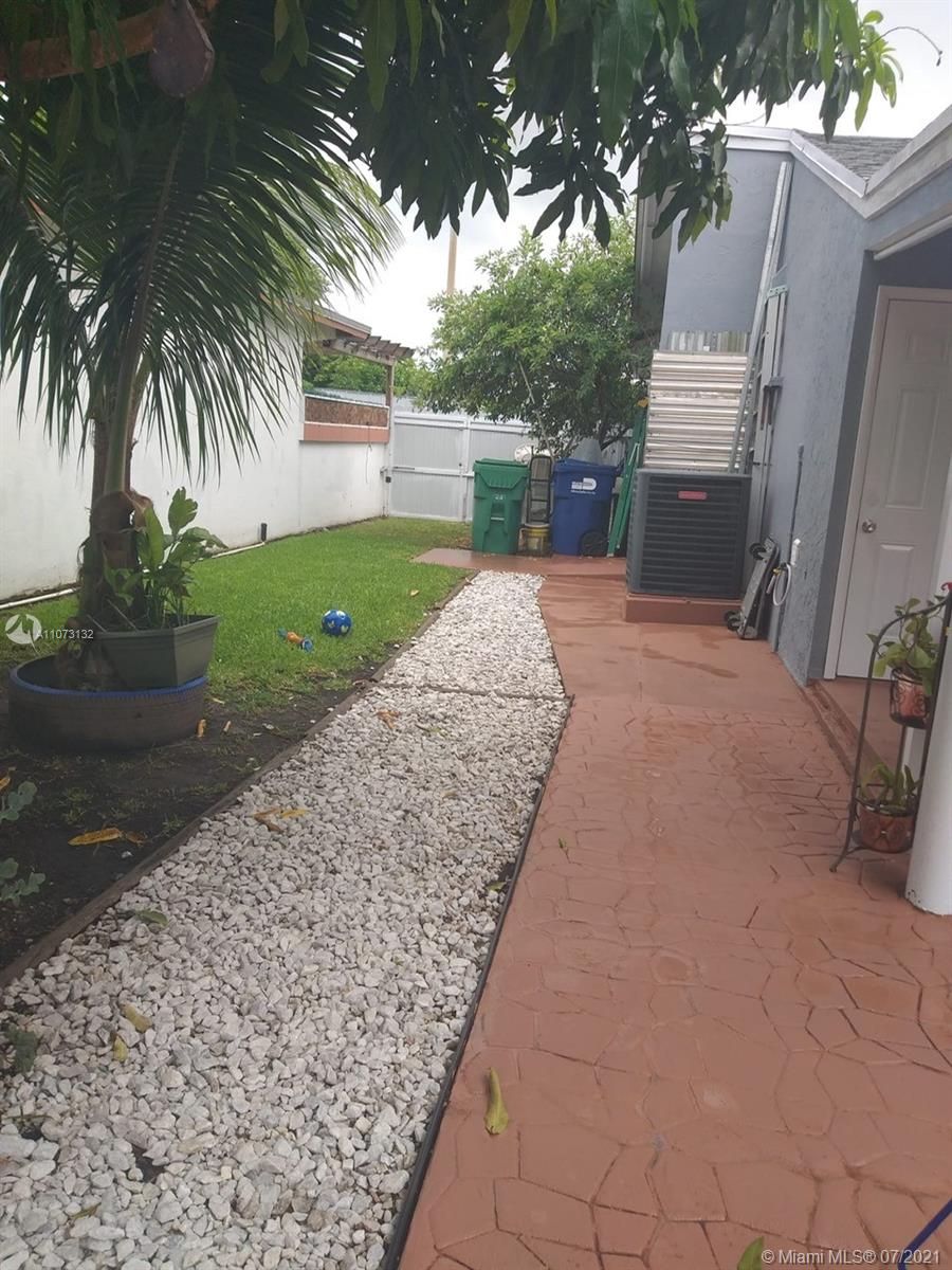 12374 Southwest 197th Terrace Miami, FL 33177 - Photo 2 of 13 a backyard of a house with fountain and barbeque oven