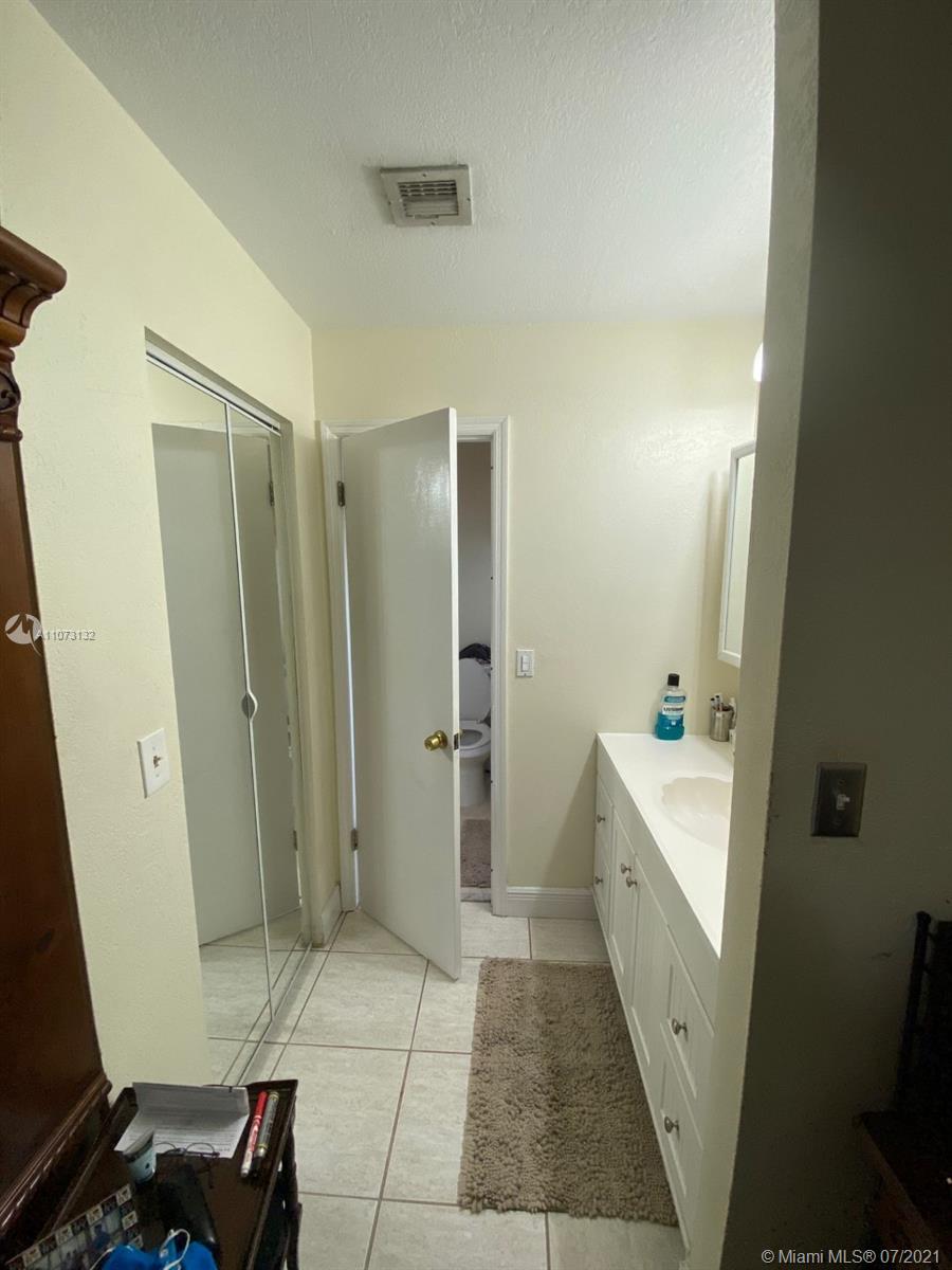 12374 Southwest 197th Terrace Miami, FL 33177 - Photo 11 of 13 a bathroom with a sink a toilet and shower
