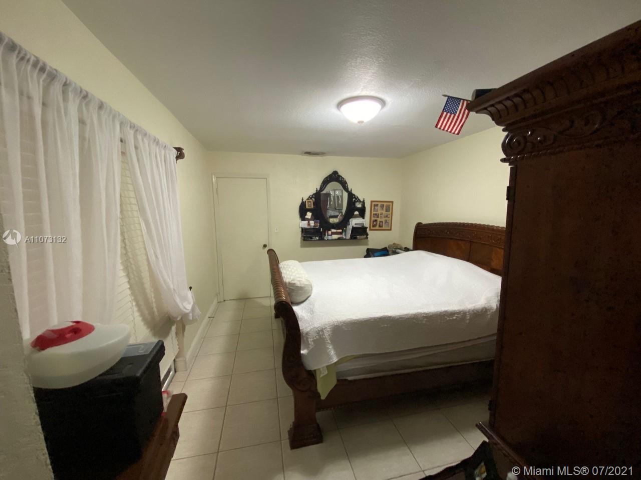 12374 Southwest 197th Terrace Miami, FL 33177 - Photo 12 of 13 a bedroom with a bed and a window