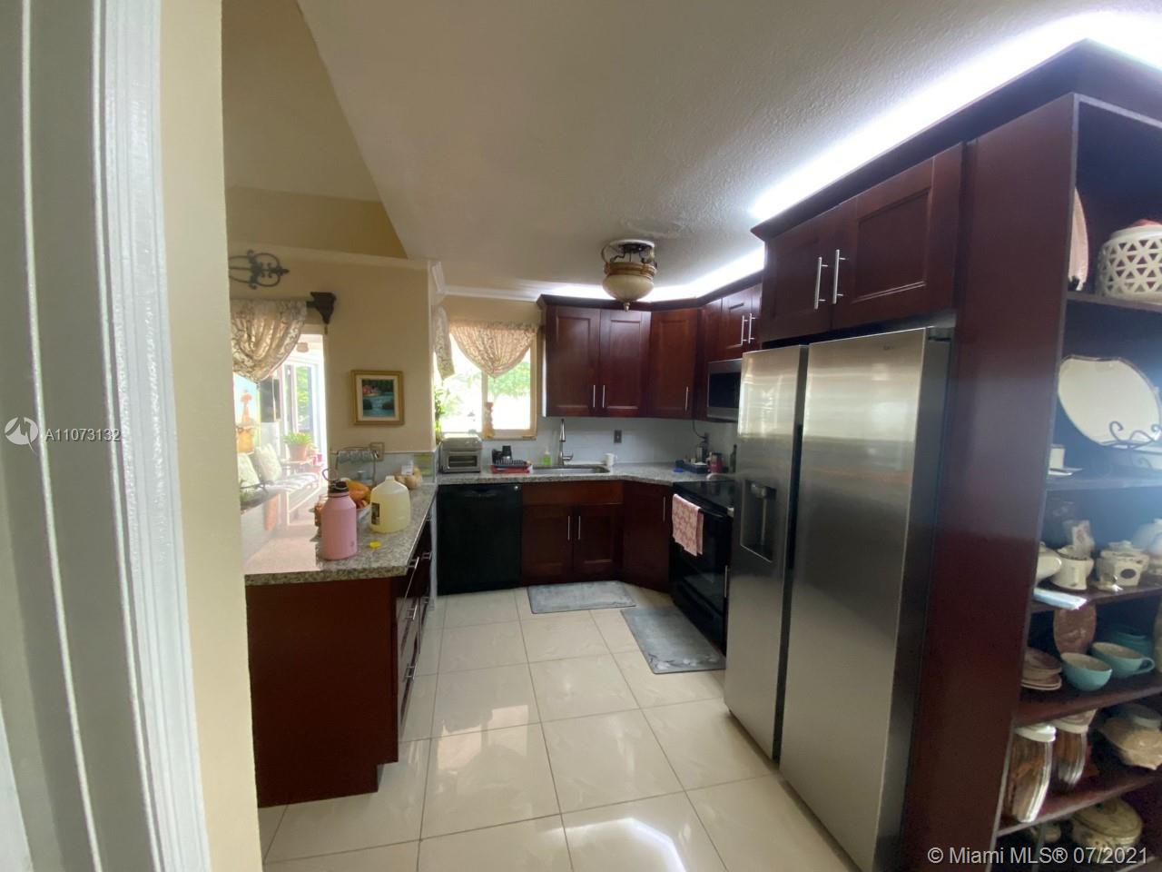 12374 Southwest 197th Terrace Miami, FL 33177 - Photo 13 of 13 a kitchen with granite countertop a refrigerator and a sink