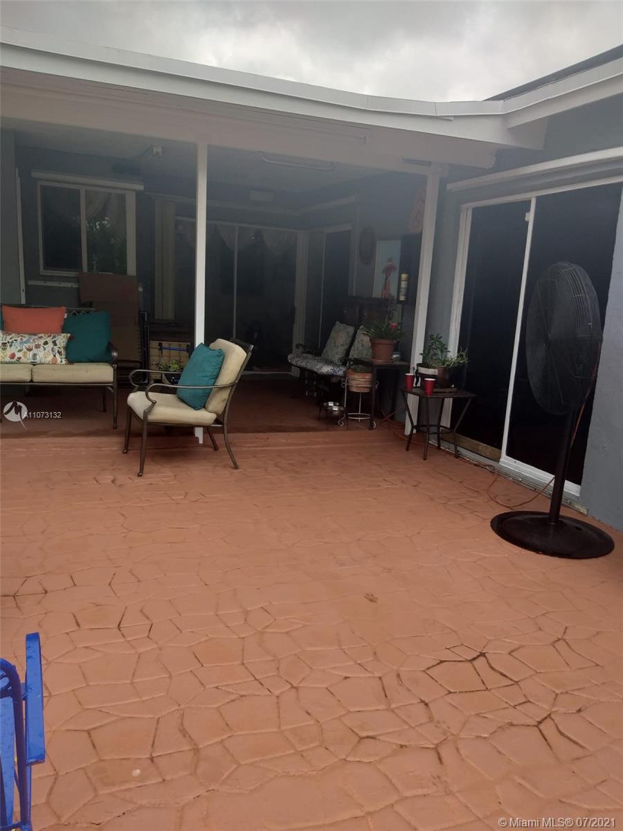 12374 Southwest 197th Terrace Miami, FL 33177 - Photo 4 of 13 a living room with furniture a window and a fireplace