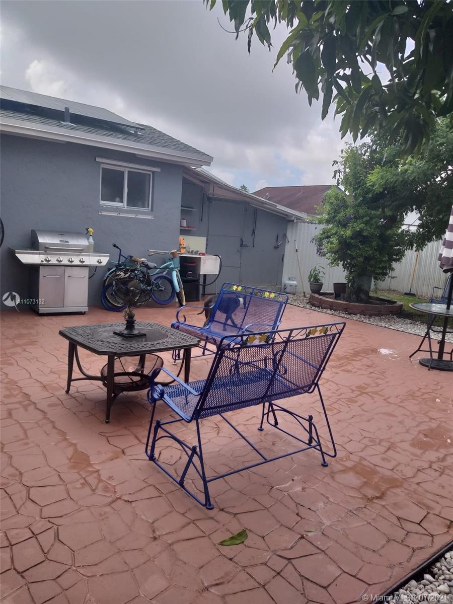 12374 Southwest 197th Terrace Miami, FL 33177 - Photo 5 of 13 a view of a backyard with furniture and a fire pit