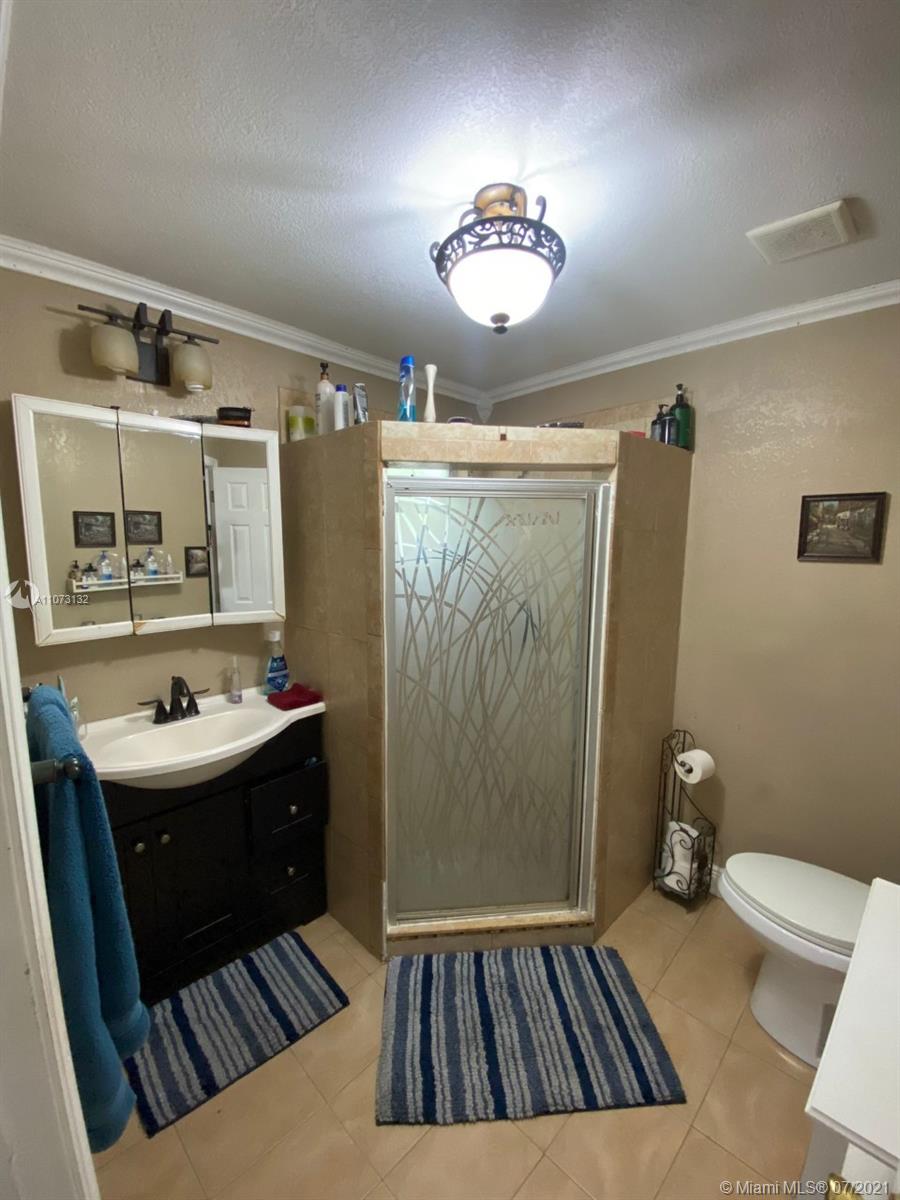 12374 Southwest 197th Terrace Miami, FL 33177 - Photo 10 of 13 a bathroom with a sink toilet and shower